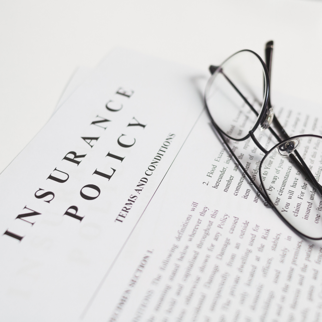 close up of an insurance document with glasses